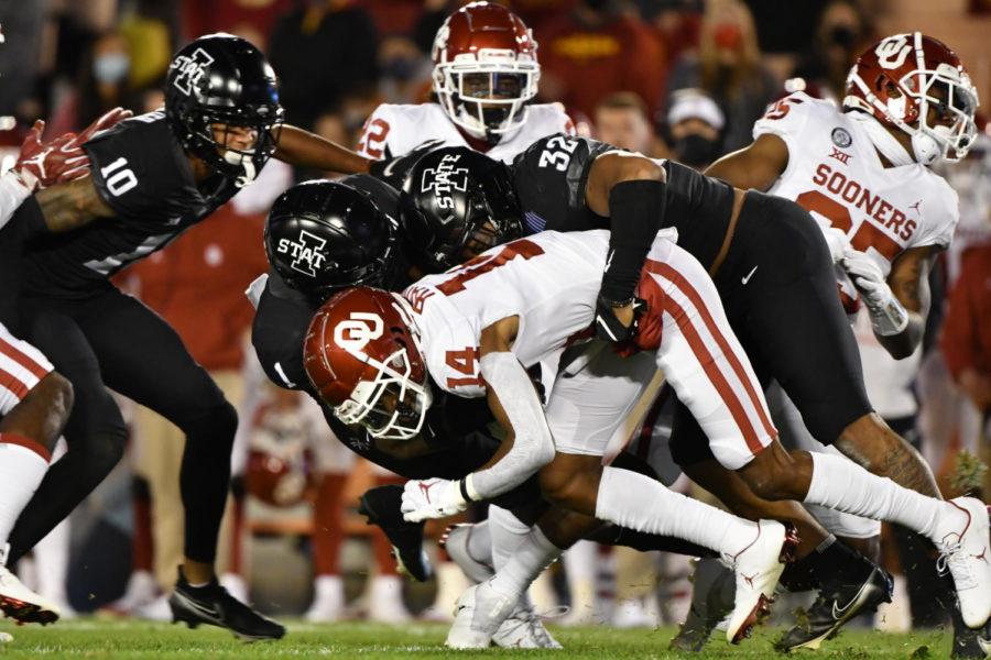 Iowa States Isheem Young and Gerry Vaughn tackle Oklahomas Charleston Rambo during the Cyclones and Sooners game Oct. 3 at Jack Trice Stadium.