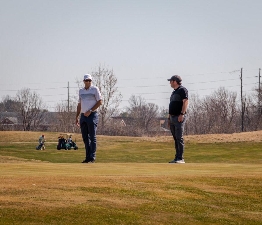 Iowa State mens golf Head Coach Andrew Tank (left) and Assistant Coach Chad Keohane (right) spectate the mens golf practice round at Coldwater Golf Links on April 3.