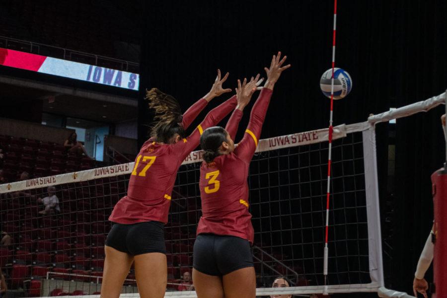 Candelaria Herrera and Jaden Newsome are seen jumping up above the net to block the ball vs. the Mavericks. 