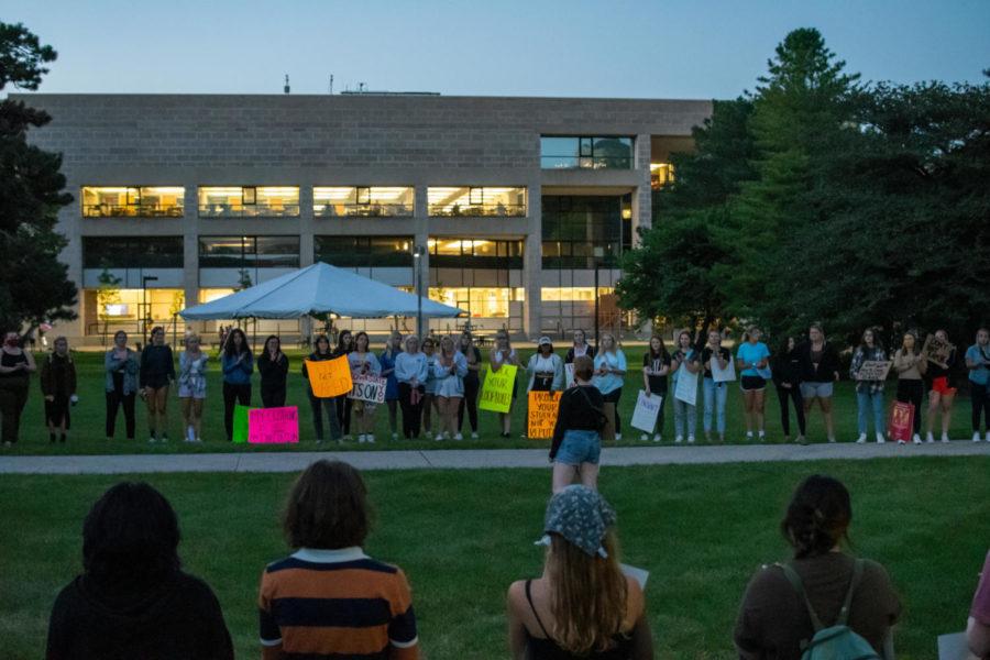Student protestors gather in a circle on the Quad outside of Parks Library. A few students step forward or yell out their personal stories and experiences.