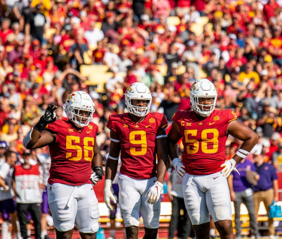 (From left to right) Iowa State defensive lineman J.R. Singleton, Will McDonald and Eyioma Uwazurike look at Iowa State's sideline for a play call against Northern Iowa on Sept. 4, 2021.