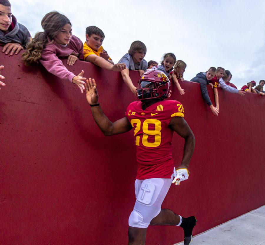 Iowa State high-fives young fans before a game against Kansas on Oct. 2. Hall finished the game with 123 rushing yards and two touchdowns, setting the school record for career rushing touchdowns in the process.