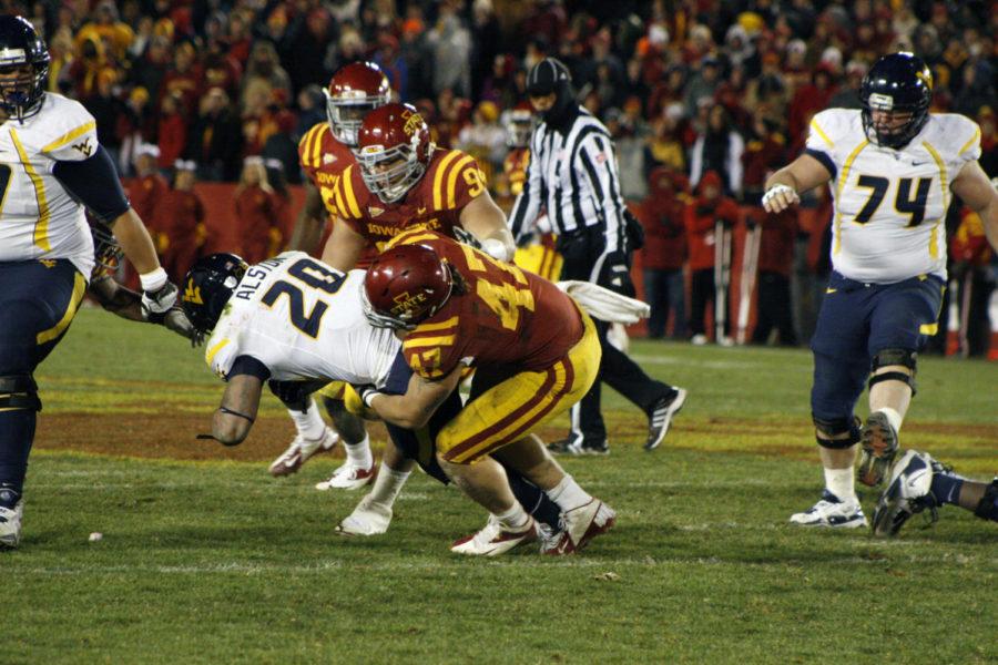 Iowa States Jake McDonough and A.J. Klein work to bring down WVU running back Shawne Alston on Friday, Nov. 23, at Jack Trice Stadium. Klein recorded a season-high 14 tackles during the Cyclones first-ever matchup against West Virginia.
