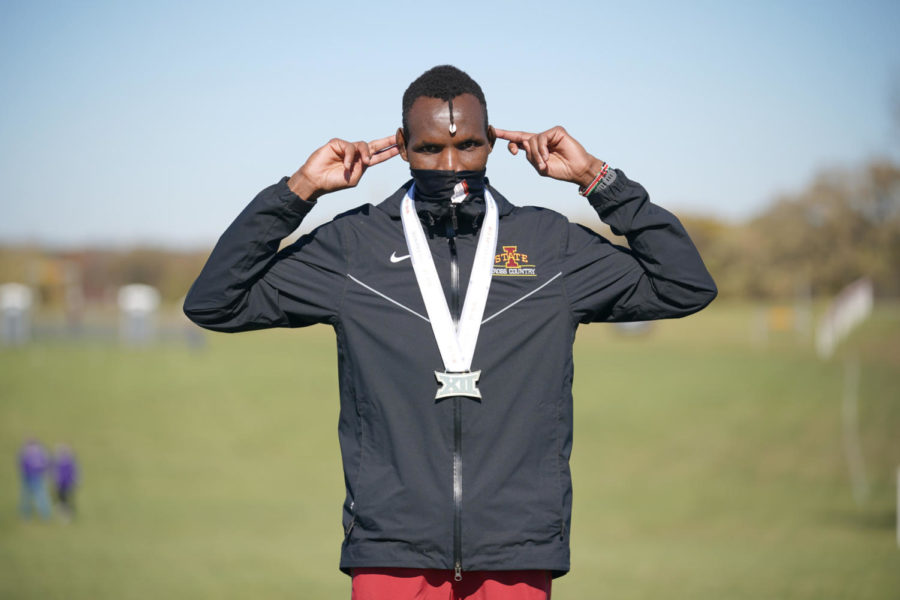 Wesley Kiptoo celebrates after winning the individual Big 12 title at the Big 12 Cross Country Championships on Friday. (Photo credit: Denny Medley/Random Photography)