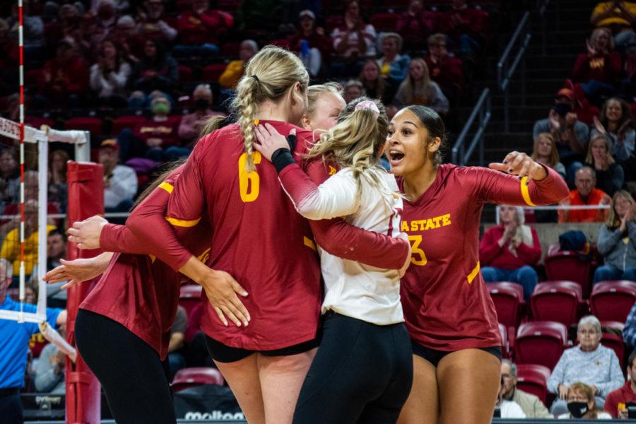 The Iowa State volleyball team comes together on the court after scoring a point against Kansas State on Nov 13, 2021.