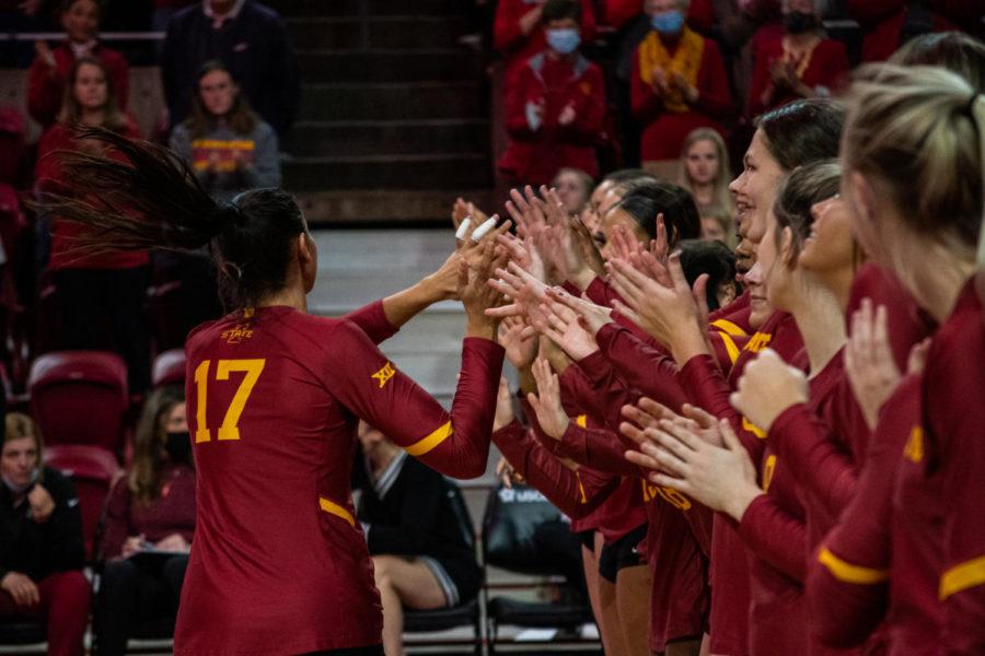 Candelaria Herrera goes down the line giving her teammates high fives against Kansas State on Nov 13. It was Herreras last match in Hilton Coliseum.