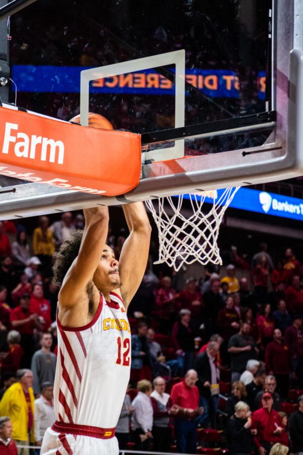 Robert Jones goes up for a dunk in the pregame warm up against Arkansas Pine-Bluff on Dec. 1 in Hilton Coliseum.