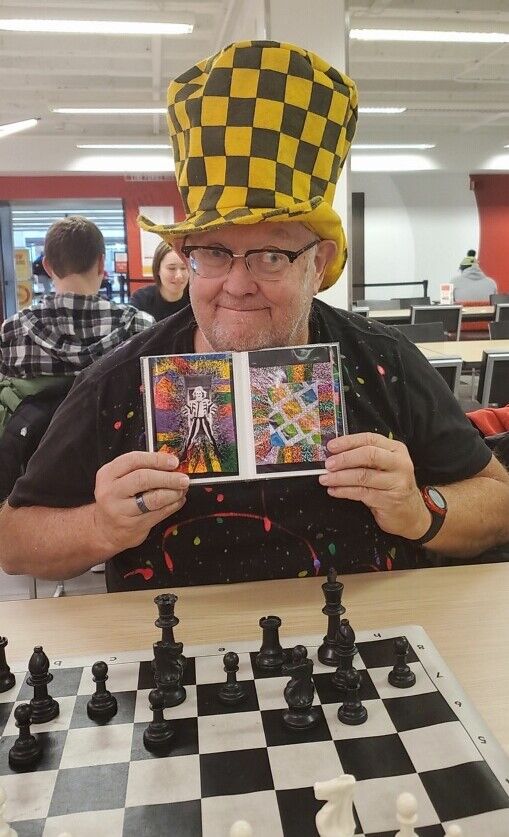 David Skaar wears his favorite party hat while playing chess at the Memorial Union.