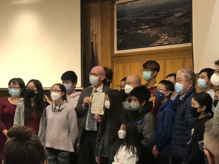 Mayor John Haila stands with a group of Ames residents as Chinese New Year becomes an official holiday in Ames during Tuesday’s City Council meeting.