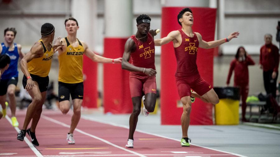 Alex Lomong (left) and Joven Nelson (right) compete in the 4x400m relay event at the Cyclone Invite on Jan. 23 at Lied Recreation Athletic Center.