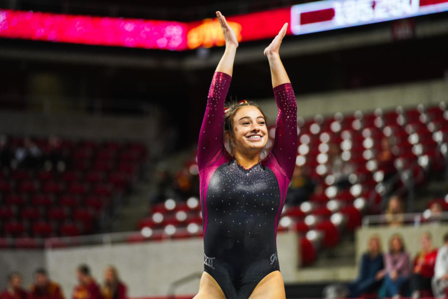 Maddie Diab hypes up the crowd during her floor routine during the Cyclones gymnastics meet against the University of West Virginia on Jan. 28.