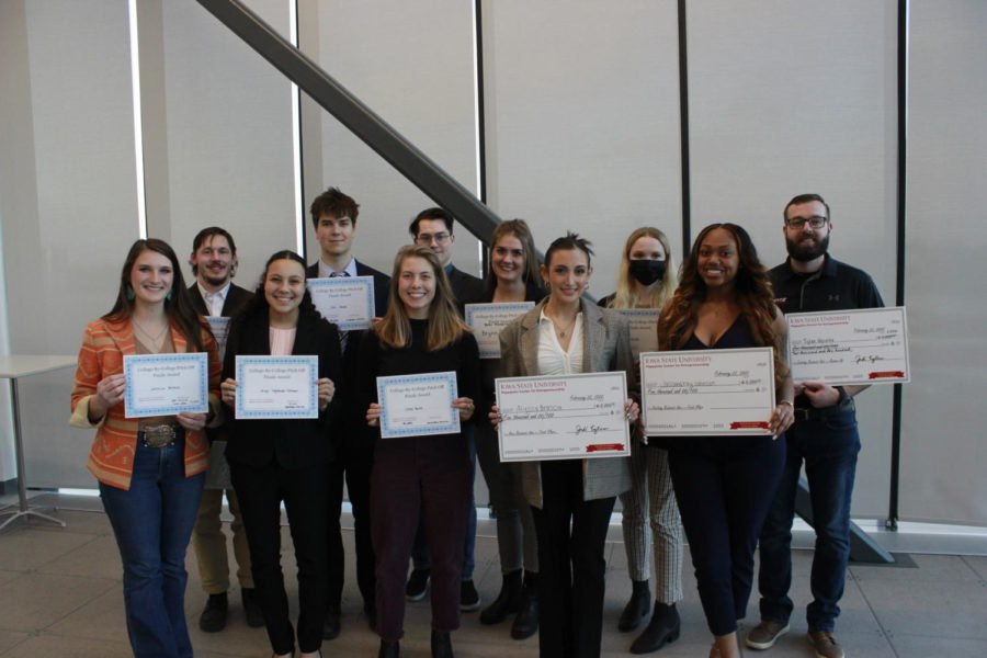 All first, second and third place winners along with honorable mentions holding their certificates and checks.
