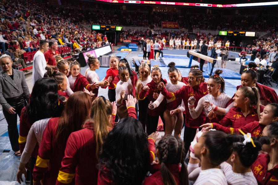 The Iowa State gymnastics team huddles during the meet against the University of Iowa on March 4.