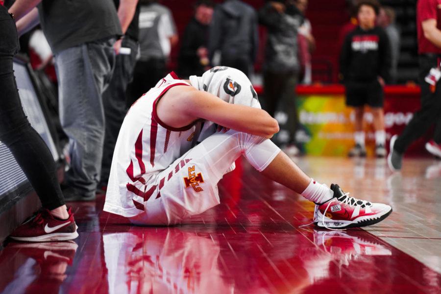 George Conditt sits on the floor of Hilton Coliseum after the Cyclones loss to Oklahoma State on March 2.