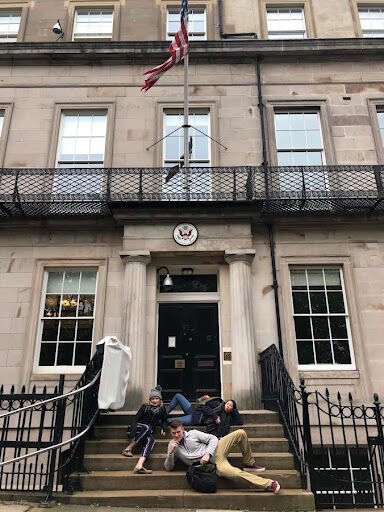 Sarah Bartlett and members of the 2019 trip to Edinburgh, Scotland posing in front of the U.S. Consulate.