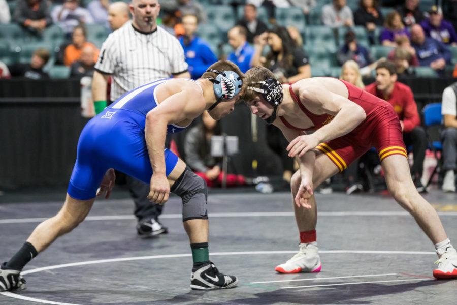 Ramazan Attasauov faces Air Forces Sidney Flores in the third place match at the 2022 Big 12 Wrestling Championships on March 6. Attasauov won 8–5 and finished third at the Big 12 Championships. (Photo by Brett Rojo/Big 12 Conference)