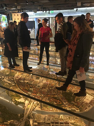 Iowa State students stand on a raised glass floor above a model of Stockholm, Sweden at the Kulturhuset, or “The House of Culture,” during the 2018 trip to Stockholm.