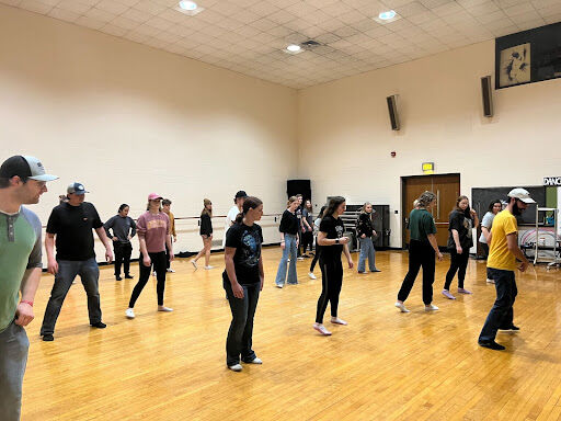 Byron Frank, treasurer of the Line Dance Club, leads a group of club members in a review of the previous weeks dance. 