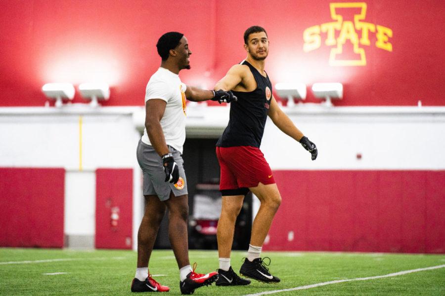 Breece Hall and Charlie Kolar talk to each other during Iowa States Pro Day on Tuesday at the Bergstrom Football Complex.