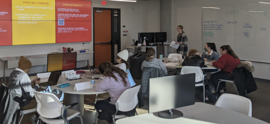 The first cohort of the Innovation and Entrepreneurship Academy photographed during a meeting time in the Student Innovation Center while learning about the logistics of financing a business.
