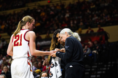 Iowa State Associate Director of Sports Medicine Denise OMara works on Lexi Donarskis hand during the 2022 Big 12 Womens Basketball Championship on March 11.