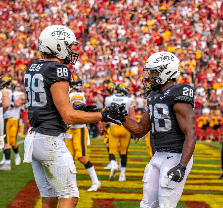 Charlie Kolar (left) and Breece Hall (right) celebrate after Halls touchdown vs. Iowa on Sept. 11, 2021.