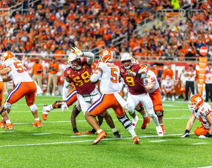 Iowa State defensive lineman Eyioma Uwazurike (left) and Will McDonald (right) rush Clemson quarterback D.J. Uiagalelei in the 2021 Cheez-It Bowl on Dec. 29, 2021.