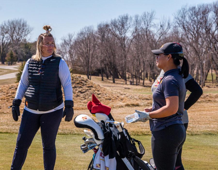 Iowa State womens golf head coach Christie Martens (left) discusses a chipping drill with then-junior Taglao Jeeravivitaporn (right). Martens has led 21 different Cyclones to 46 All-Big 12 honors throughout her coaching career at Iowa State.