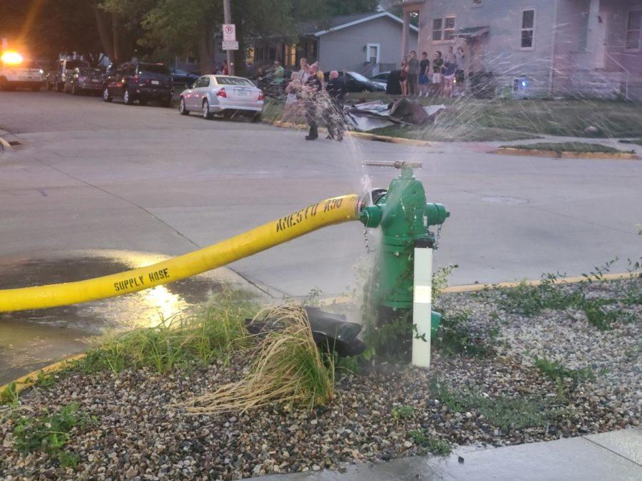 Firefighters open a fire hydrant to battle a fire on Friday. 