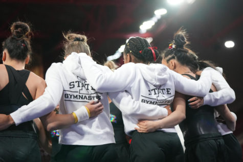 Iowa State gymnastics team members huddle together at the 2022 Big 12 Gymnastics Championships on March 19 in Denver, Colorado.