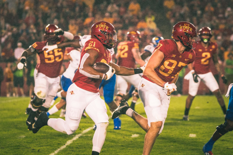 Jirehl Brock runs behind tight end Easton Dean in the Cyclones 59-7 win over Kansas on Oct. 2, 2021.