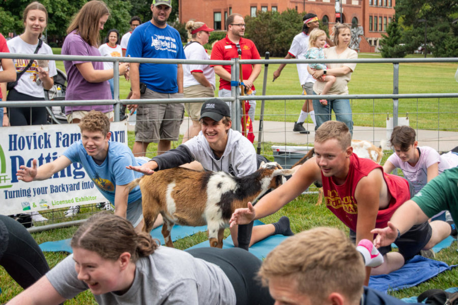 Students strike a yoga pose during goat calisthenics at the Greatest of All Time Breakfast on Aug. 20
