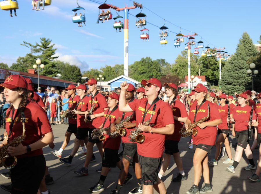 Cyclone Marching Band saxophone players, pictured while marching through the Iowa State Fair.