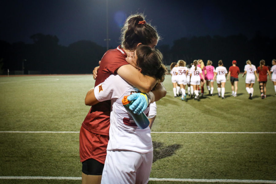 Iowa State soccer players hug on another after beating Iowa on Sept. 8