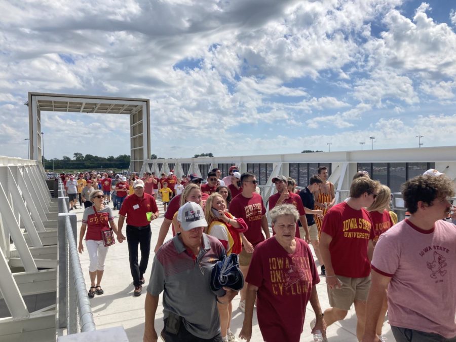Thousands of football fans cross the newly opened pedestrian bridge at the first football game of the 2022 season. 