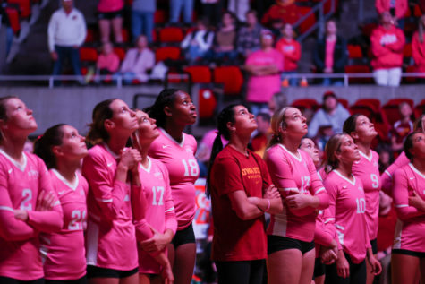 Cyclone volleyball players look up at the scoreboard as the pregame video is shown in Hilton Coliseum on Oct. 12.