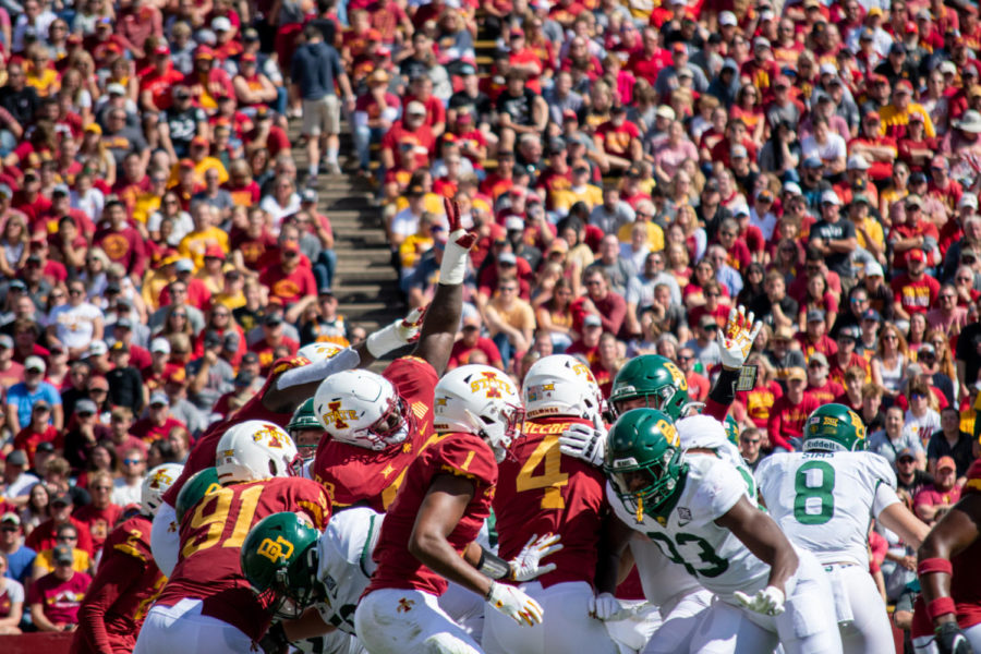 Group of Cyclones including linebacker Colby Reeder attempt to block kick from Baylor.