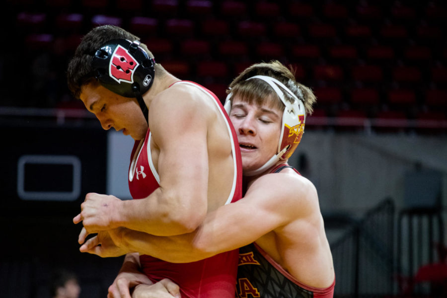 ********* lifts up a wrestler from Wisconsin in the Harold Nichols Cyclone Open on Saturday Nov. 26, 2022.