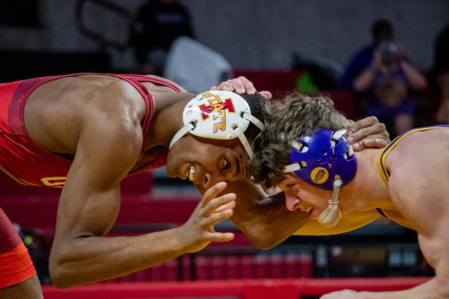 Cam Robinson comes head-to-head with a wrestler from UNI in the Harold Nichols Cyclone Open on Saturday Nov. 26, 2022.
