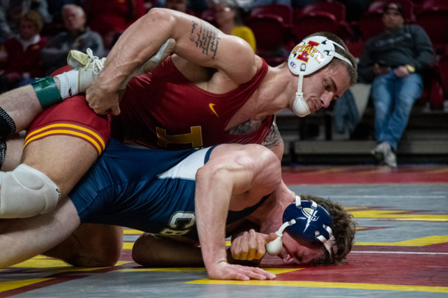 Iowa States Julien Broderson pulls the leg of California Baptists Zach Rowe during the match on Saturday Nov. 12, 2022.