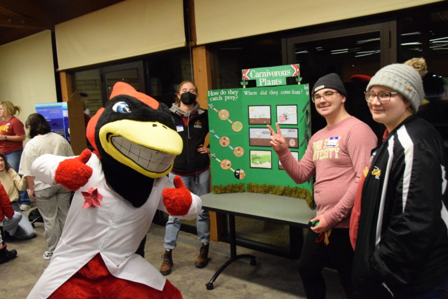 Cy posing with Kyra Oberbroeckling, a senior in biology (back) Sebastian OBryon, a senior in microbiology (middle) and Morgan Vorwald, a senior in animal science (right).