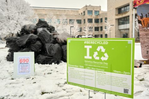 The Iowa State recycling coordinator set up an 8-foot-tall pile of trash as part of an America Recycles Day campaign. 