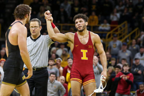 Iowa States Yonger Bastida gets his hand raised after defeating Iowas Jacob Warner during the CyHawk wrestling dual on Dec. 4, 2022.
