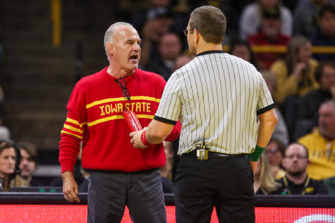 Iowa State Head Coach Kevin Dresser talks with an official during the CyHawk wrestling dual on Dec. 4, 2022.