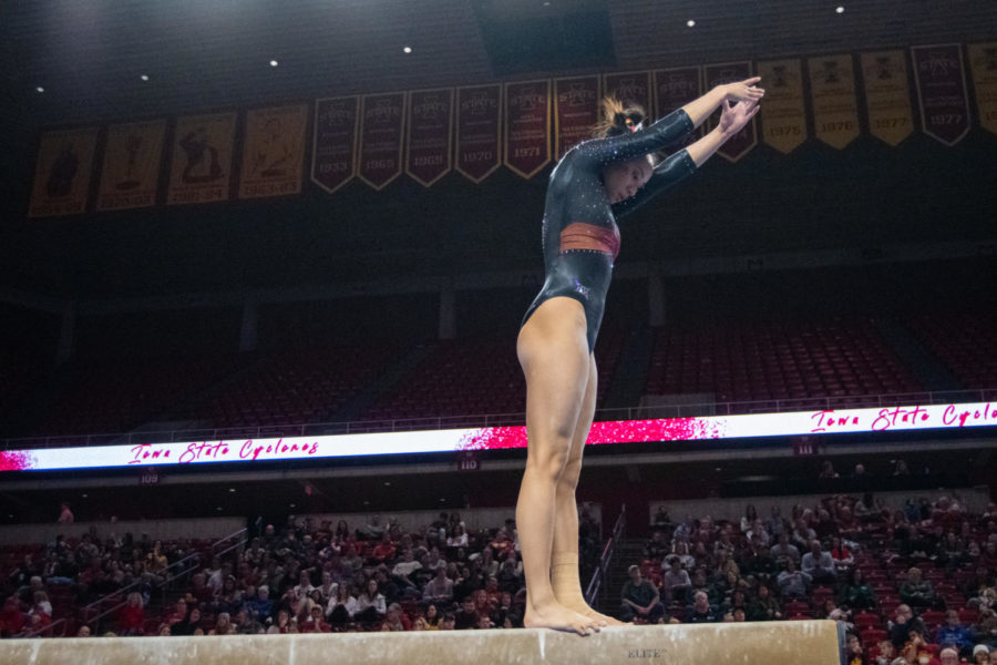 Loganne Basuel warms up her beam routine during the meet against Eastern Michigan and UC Davis in Hilton Coliseum on Jan. 20, 2023.