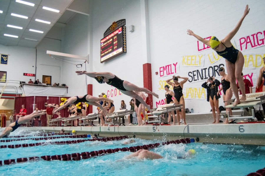 Iowa State swimmers trade places during a relay against UNI and West Virginia in Beyer Hall on Jan. 21, 2023.