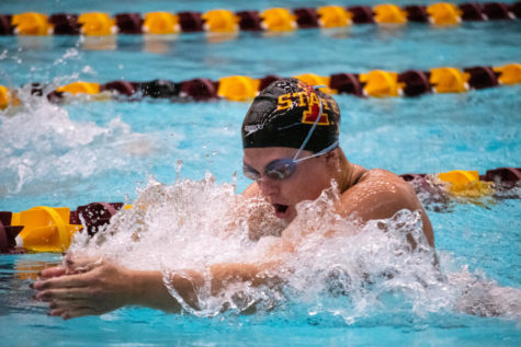 An Iowa State swimmer bobs up above the water during her breaststroke race against UNI and West Virginia in Beyer Hall on Jan. 21, 2023.