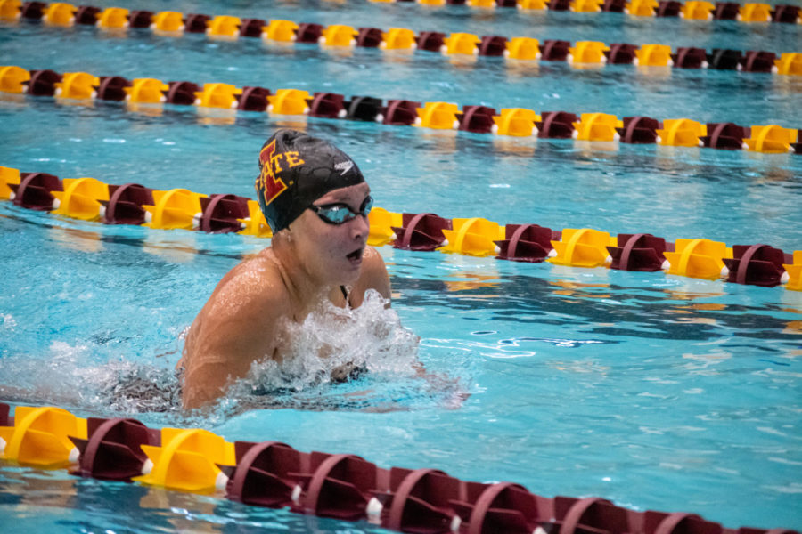 An Iowa State swimmer bobs up above the water during her breaststroke race against UNI and West Virginia in Beyer Hall on Jan. 21, 2023.