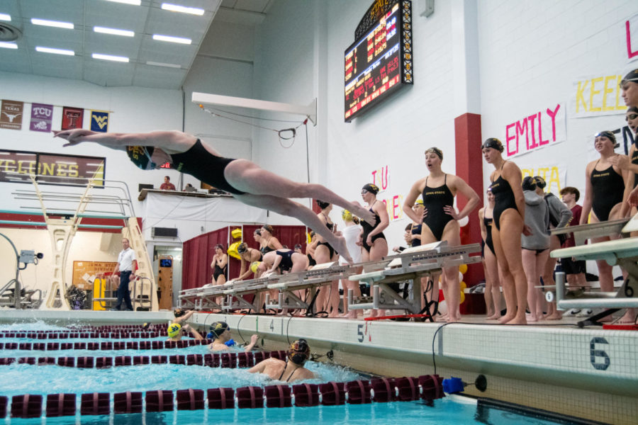 Iowa State swimmers trade places during a relay against UNI and West Virginia in Beyer Hall on Jan. 21, 2023.