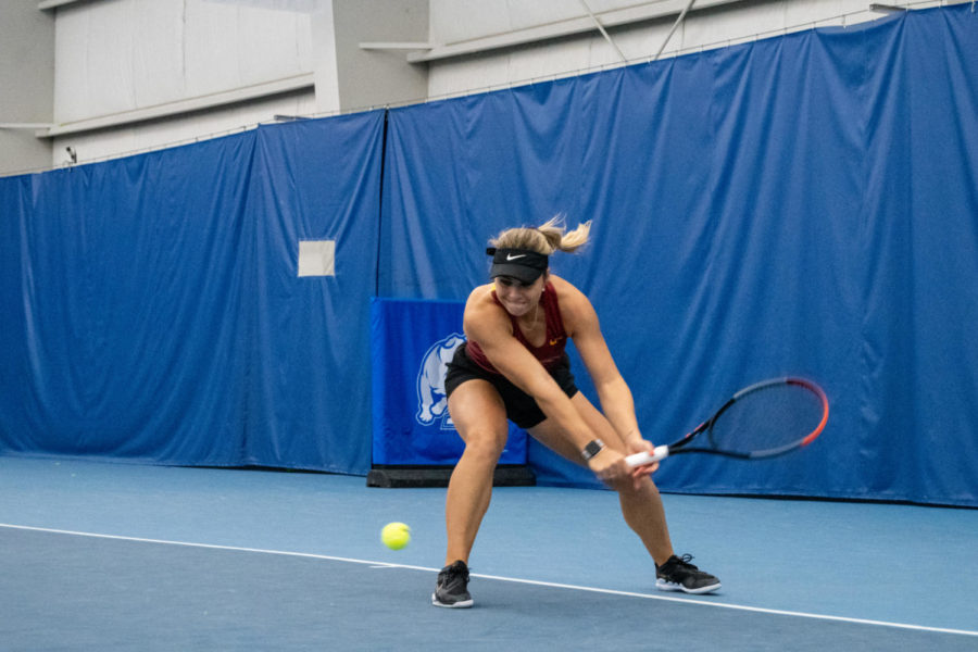 Miska Kadleckova scrapes the ground with her racket, barely getting it underneath the ball during her singles match against Drake University at the Roger Knapp Tennis Center on Jan. 14, 2023.